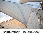 Small photo of Close up of a flying jib, detail of a sailing vessel on sunset