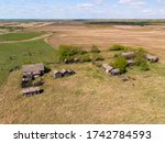 Aerial view of farm houses and various other structures that were built by the first farming settlers in the Prairie Province of Saskatchewan, Canada. Many buildings date back to the early 1900