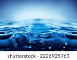Small photo of Water splashing blue watery background