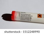 Small photo of Sodium carbonate in a plastic tube with red cap