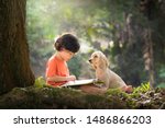 Asian boy and dog. Kid read book. Child and puppy under tree. American Cocker Spaniel home pet. Domestic animal. School and education. Nature and park. Early learning. Summer outdoor. Best friends. 