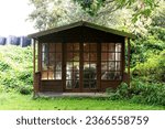 Small photo of Wooden shed with glass doors and windows