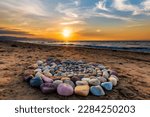 Small photo of Sacred Ritual Stones For Spiritual Ceremony Are Are Arranged In A Circle During Sunset On The Beach
