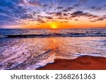 Small photo of Sun Rays Are Bursting Forth On A Colorful Ocean Sunset Horizon With A Flock Of Birds Flying In The Sky
