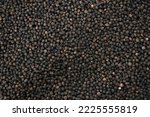 Black pepper background. black peppercorns spices. herb. bed covered in full screen. Dry black pepper seeds. Top view. Flat design. Macro spice background