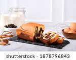 Concept White Background Bakery, Loaf Marble Cake Slice on Stone Black Plate with Ingredient at Background
