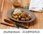 Swedish Meatball with Mushroom Brown Sauce and Boiled Vegetable, Served with Creamy Mashed Potato. On Wooden Table