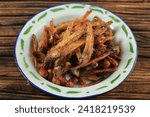 Small photo of Close Up Sambal Balado Teri Kacang, Fried Anchovy and Peanut Stir Fry with Sweet and Spicy Chilli Sauce until Caramelized. Indonesian Daily Menu