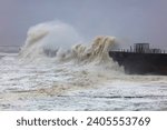 Small photo of Huge Waves battering a sea defence wall during a storm at Hartlepool Headland, County Durham, England, UK.