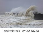 Small photo of Huge Waves battering a sea defence wall during a storm at Hartlepool Headland, County Durham, England, UK.