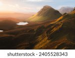 Small photo of Vibrant golden light over epic mountain landscape of the rugged, contoured terrain of the Cleat at the Quiraing on the Isle of Skye, Scotland.