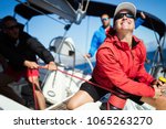 Attractive strong woman sailing with her boat