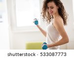 Sporty beautiful woman exercising at home to stay fit