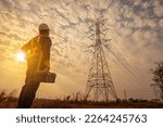 Asian electrical engineer wearing safety gear working high voltage pylon Engineering work on high-voltage pylons at power stations using drones to view power generation planning from high-voltage pylo