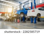 Blurred image of car inspection service center with modern tools