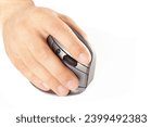 Close-up of male hand clicking on vertical computer mouse. Isolated vertical mouse. Concept of body health. Office syndrome concept. Carpal Tunnel Syndrome.