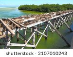 Small photo of Decommissioned wooden bridge from mainland to Boca Paila Peninsula, spans the outlet of the lagoon to the Caribbean Sea, Puente de Boca Paila, Q.R., Mexico - September 2020: