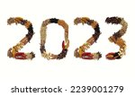 Small photo of 2023 Written with Spices and Condiments Like Cardamom, Cloves, Cinnamon, Coriander, Black Pepper, Fennel, Black Cumin, Fenugreek, Bay Leaf, Red Chili, Happy New Year 2023 Conceptual