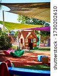 Small photo of Photography of a playground at a child care center with a cubby house and play equipment