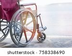 close up view of empty wheelchair with Pavement handicap symbol 