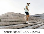 Small photo of Athlete trainer exercises to warm up muscles. Hobby jogging in running shoes. Mental and psychological health. A healthy man who trains actively interval training.