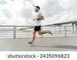 Man jogging on a sunny day with ...