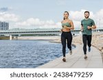 Couple jogging by the river ...