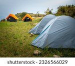 Small photo of June 28th 2023, Nag tibba Uttarakhand ,India. Camps with orange outer fly on a Camp Ground. Nag Tibba, Himalayan region of Uttarakhand. Trekking And Camping