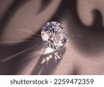 Small photo of Close up of a pare of blue and white diamonds of different cuts with shadows.