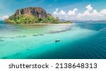Small photo of Tropical turquoise water with a Thai longtail boat motoring past a coral reef and Ko Poda Island in the Andaman sea of Krabi Thailand