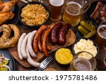 Oktoberfest dishes: beer, pretzel, sausage, stewed cabbage, potato salad, half of chicken and ribs