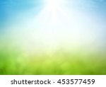 Earth day concept: Abstract blur beautiful soft green bokeh light meadow and blue sky on autumn sunrise background