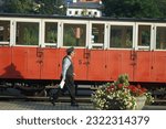 Small photo of ticket collector at the train station, railway, conductor, guard, old red train, Austrian, mobility, industry, traveling by train, economy, vacation, holiday, tourism