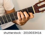 Small photo of Guitar chord, C major chord. Male hand playing guitar chord