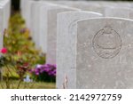 Small photo of Bayeux, Normandy, France - Sep 16, 2019: A row of graves, decorated with vibrant flowers, is lined up in the Bayeux War Cemetery in Bayeux, France, with the phrase "Fear Naught" visible in front.