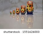 Small photo of Russian dolls Matryoshka lined up in increasing height with reflection on the floor to depict growth, sensex, stock market or 5 star review