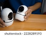 Small photo of Conceptual man operating ip camera,White IP cameras, very popular for security purposes.