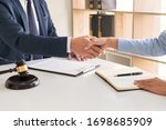 Small photo of Handshake after cooperation between attorneys lawyer and clients discussing a contract agreement hope of victory over legal fighters Concepts of law advice