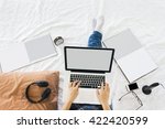 Top view girl or lady sitting on bed surfing internet via laptop, online shopping or business working on blank empty laptop screen in relax mood with books , cellphone or smartphone and alarm clock