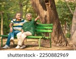 Small photo of happy Old couple spending time together and watching some opposite site and pointing there.