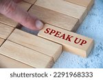 Small photo of Finger pushing wooden block with written text speak up. Courage and speak up concept.
