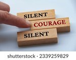 Small photo of Finger pushing wooden block with red written text courage. Courage and speak up concept