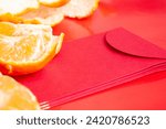 Small photo of Peal Mandarin oranges and Chinese New Year red packet. Chinese New Year celebration concept.