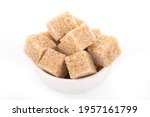 brown sugar cubes. brown sugar in white bowl on white background. sugar cubes, cane sugar
