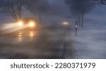 Small photo of Cars in winter in fog and poor visibility.