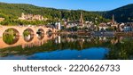 Small photo of Heidelberg wide angle old town panorama with castle, “Karl Theodor Bridge“ and its twin tower gate, Church of the Holy Spirit. Reflection in the water of River Neckar on a sunny summer day in Germany.