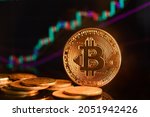 Bitcoin and cryptocurrency investing concept. Bitcoin cryptocurrency gold coin. Trading on the cryptocurrency exchange. Trends in bitcoin exchange rates. Rise and fall charts of bitcoin.