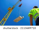 construction worker with crane. Hook cargo crane on the sky background. crane on a construction site