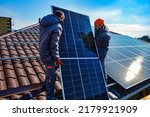 Solar panels on roof.  Installing a Solar Cell on a Roof. Workers installing solar cell farm power plant eco technology.
