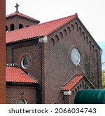 Small photo of DUBUQUE, IOWA, October 28, 2021–DUBUQUE, IOWA, October 28, 2021–Landscape photo of beautiful old historic building with red tile roof and bell tower taken on overcast day.